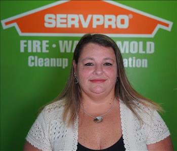 Woman in front of SERVPRO logo