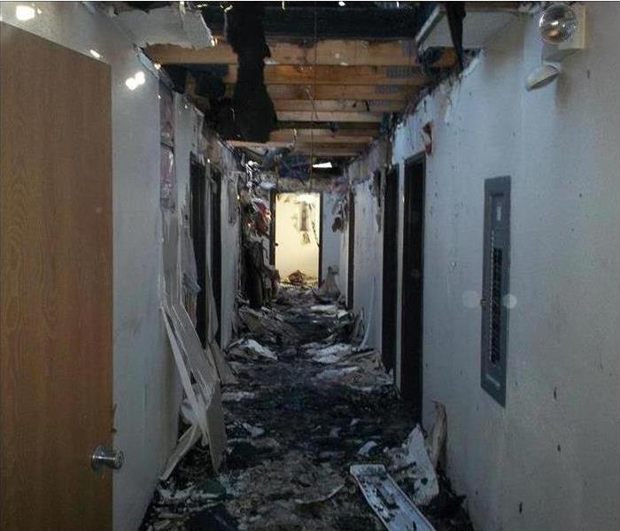 Ceiling collapsed and burned in the hallway of a property